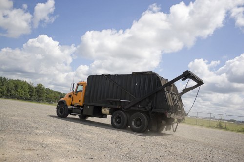Workers sorting recyclable materials at a borough recycling hub